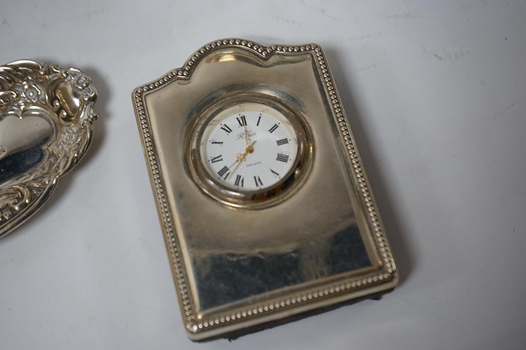 Assorted small silver including a small Reynolds Angels pin tray, Birmingham, 1900, 11.1cm, one other small dish, a modern mounted timepiece, a French mounted glass salts bottle, a photograph frame, a mounted glass whisk